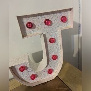 J Initial Light up from Justice